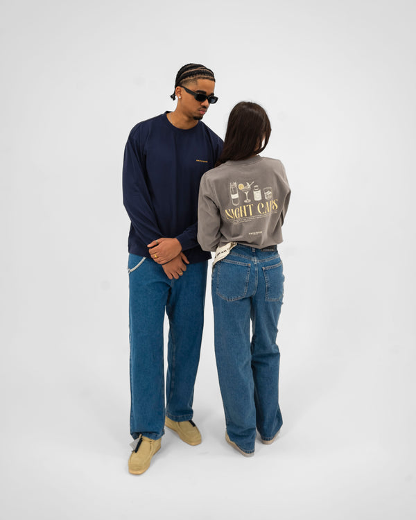 This image features a stylish women's long sleeve t-shirt, part of the Cropped Night Caps collection. The tee, crafted from 100% carded cotton, boasts a heavy weight of 240gsm, ensuring both comfort and durability.