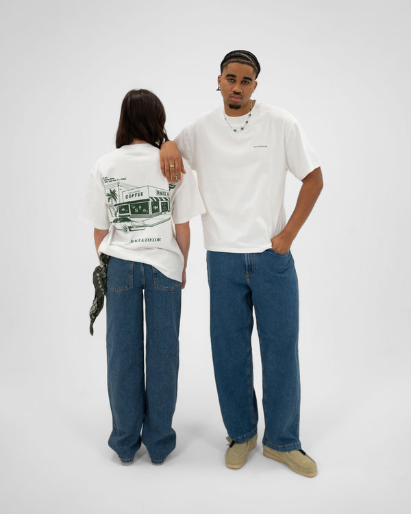 Two models wearing white crew neck t-shirts with text on them, standing in a casual pose against a white background.